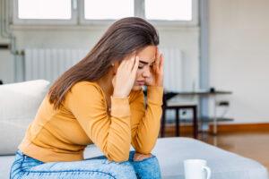 A woman feeling tired after taking Tirzepatide. Over time, her body will adjust to her new energy level, and the fatigue will pass.