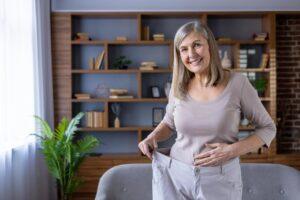 A woman who has lost weight smiles and wonders, “How long does it take for tirzepatide to suppress appetite?”