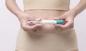 A woman looks at a blue injection pen, wondering if semaglutide is safe and what she should know before starting.