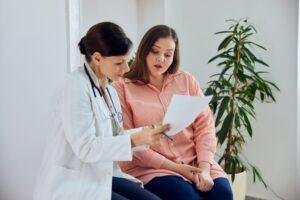 Doctor discussing weight loss program with a patient, including tirzepatide vs. semaglutide and which is best for them.